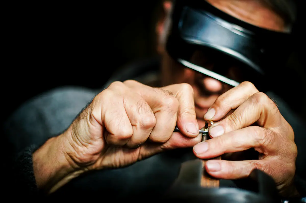 A person holding a metal tool