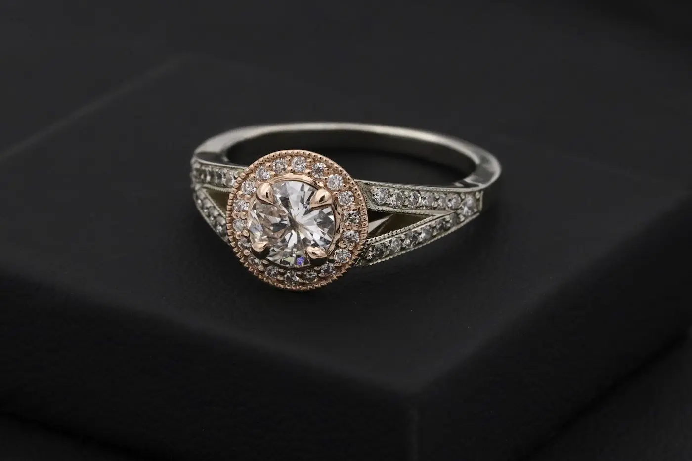 Silver diamond ring on a black box