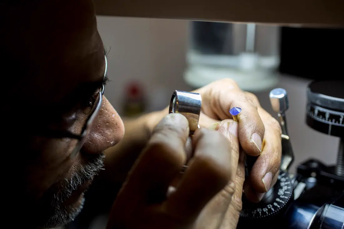 Close-up of a jeweller inspecting a gemstone
